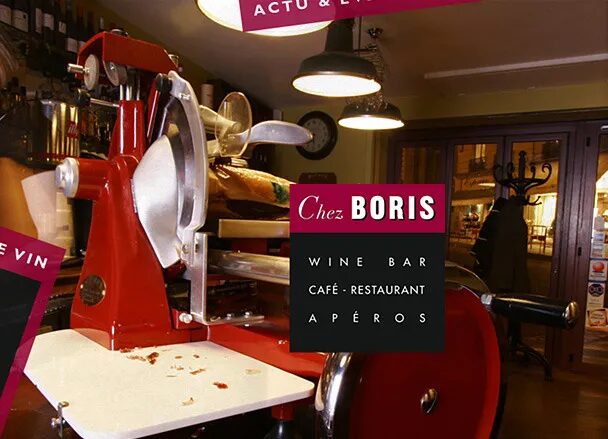 Interior of the Chez Boris wine bar with red ham slicer, warm café-restaurant atmosphere and elegant visual identity